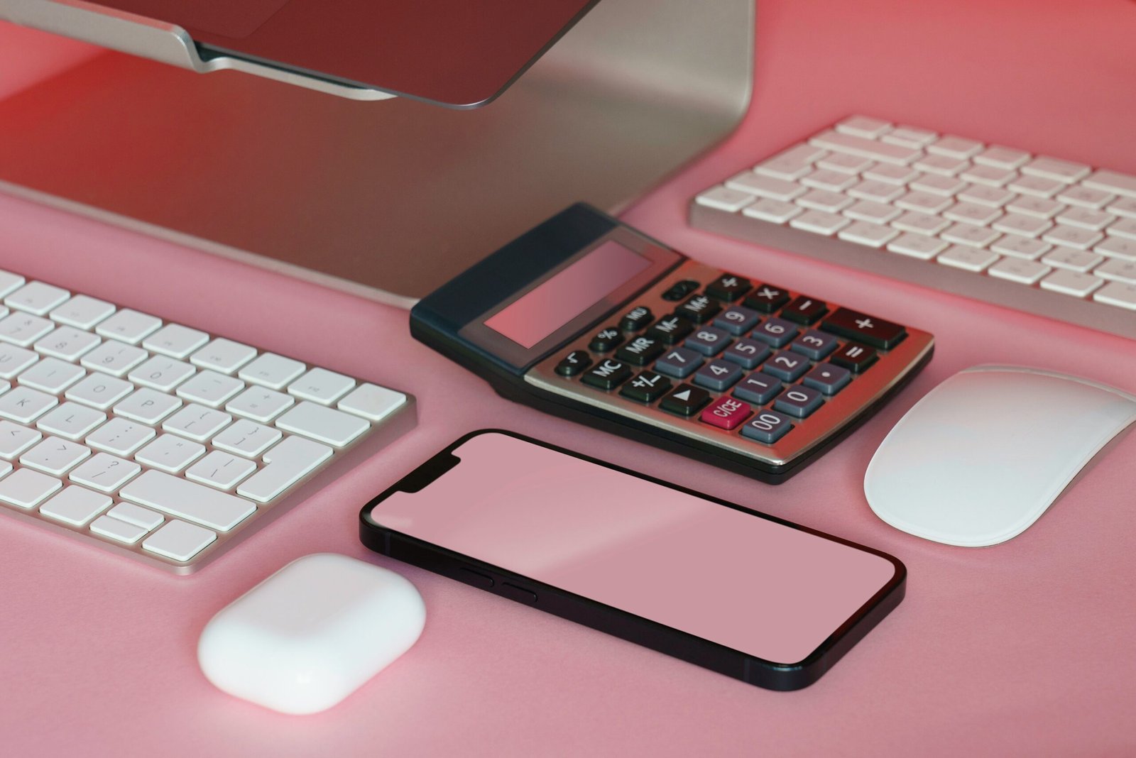 a desk with a keyboard, mouse, and cell phone